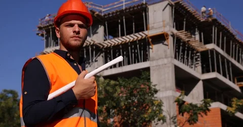 Worker Man Portrait Look Camera Hold Blueprint near Unfinished Apartment Project Stock Footage