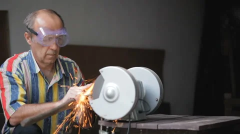 Worker man sharpen ax tool at industrial machine Stock Footage 67578250