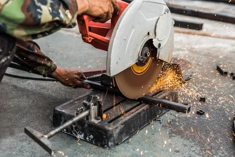 Worker man using machine cutting steel Stock Photos