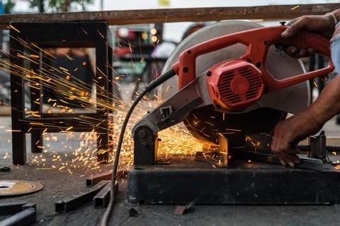 Worker man using machine cutting steel Stock Photos