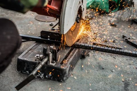 Worker man using machine cutting steel Stock Photos