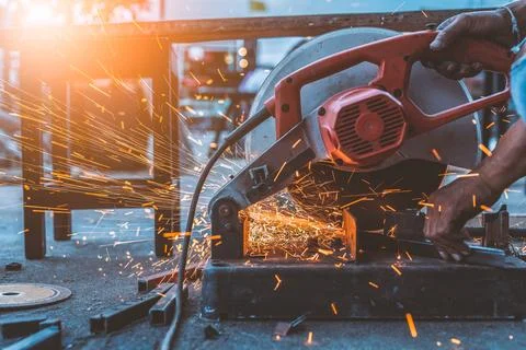 Worker man using machine cutting steel Stock Photos