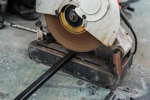 Worker man using machine cutting steel Stock Photos