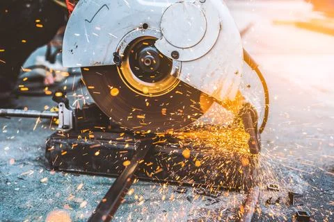 Worker man using machine cutting steel Stock Photos