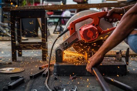 Worker man using machine cutting steel Stock Photos