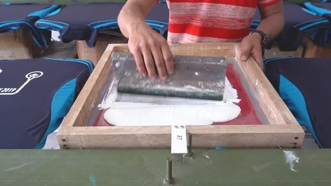 Worker man using Silk screen printing on clothing fabric Video stock 106792047
