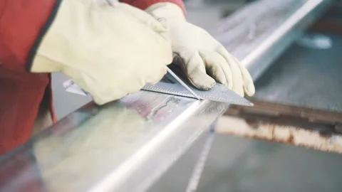 Worker man wearing gloves measuring a metal tube with a triangle Stock Footage 137526196