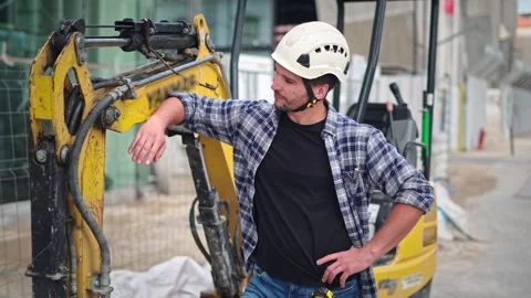 Worker man work at construction site. Excavator or digger driver guy portrait. 스톡 동영상 271222051