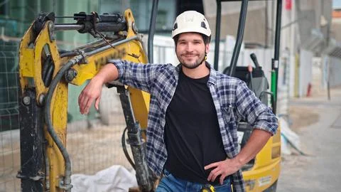 Worker man work at construction site. Excavator or digger driver guy portrait. Foto stock