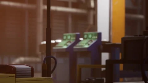 A worker is managing equipment in a factory setting during the morning shift Stock Footage 344997917