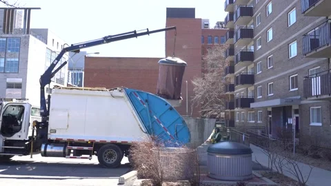 A worker manipulates a big garbage bin with a device 스톡 동영상 135271315