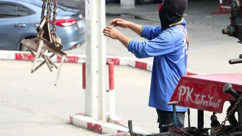 A worker manipulates a chains hanging on a crane Stock Footage 219191556