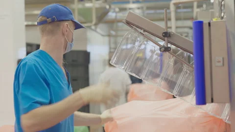 Worker Manually Attaches Bottles For MIlk Production On Industrial Line Conveyor Stock Footage 292831117