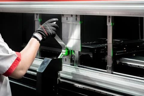 Worker at manufacture workshop operating cidan folding machine Stock Photos