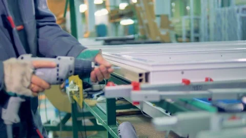 Worker manufacturing plastic window. Assembly line of PVC windows and doors. Stock Footage 83387467