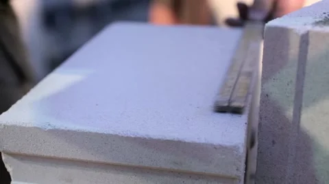 Worker marks a cement block to be cut Stock Footage 60443160