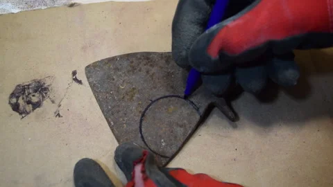 The worker marks the mark on the axe with a marker for sawing. Stock Footage 156340028