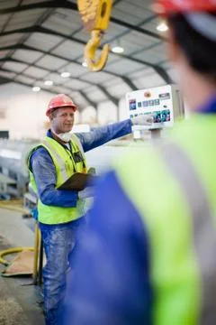 Worker in mask using machinery Foto stock