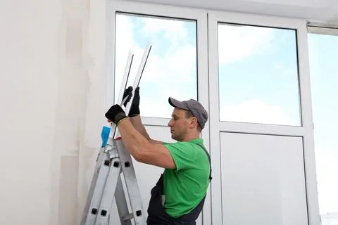 Worker with materials for window installation indoors Stock Photos