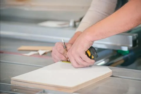 Worker measures the exact size of the cutting parts Stock Photos