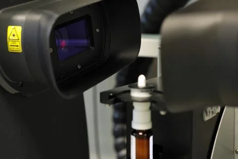The worker measures the size of the particles and drops of the spray. Pharmac Stock Photos