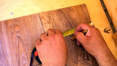 Worker measures with tape measure linoleum Stock Footage