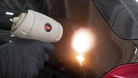 A worker measures the thickness of the paint on the car Video stock 240900405