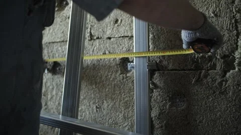 Worker measures the wall with a tape measure Stock Footage 201382535