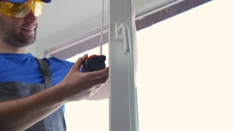 Worker measures window frame size with tape measure Stock-Footage 197266833