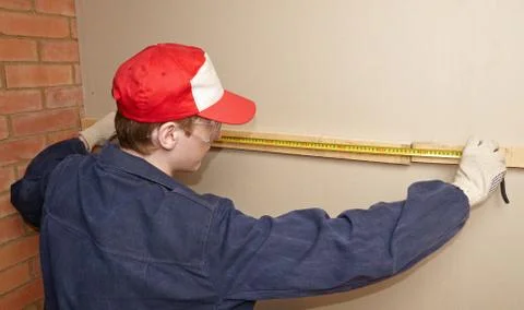 The worker measures wooden panel Stock Photos