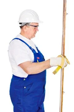 Worker measuring the board Stock Photos