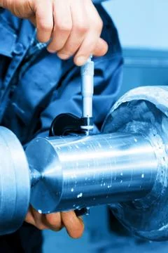 Worker measuring on industrial turning machine. Industry Stock-Fotos