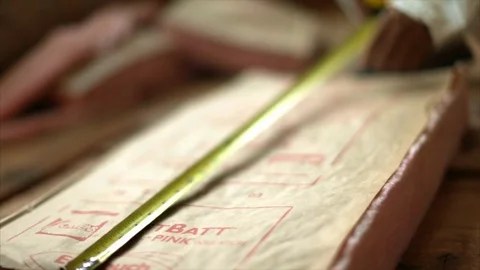 Worker measuring insulation before installing it. Stock Footage 88405826