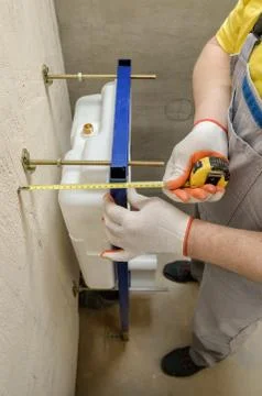 A worker is measuring. Stock Photos