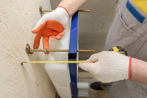 A worker is measuring. Stock Photos