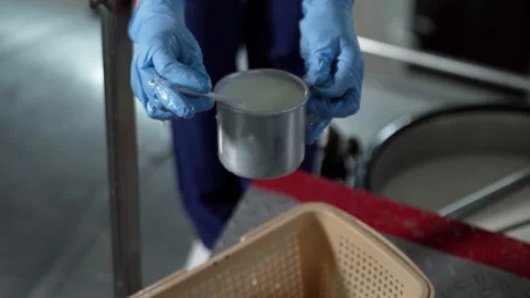Worker is measuring the temperature of the dairy product sample at manufacturing Stock Footage 251139768