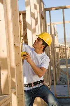 Worker Measuring Timber At Construction Site Stock Photos