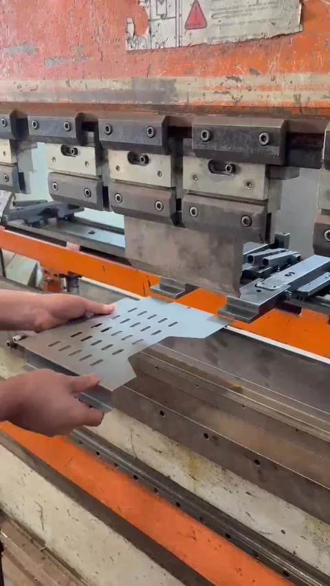 Worker Measuring Upper Mold Tooling on Industrial Press Brake Machine Stock Footage 342586824