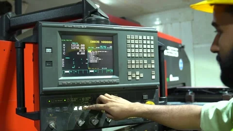 Worker In A Metalworking Factory Operating A Computerized CNC Machine During 스톡 동영상 332137297