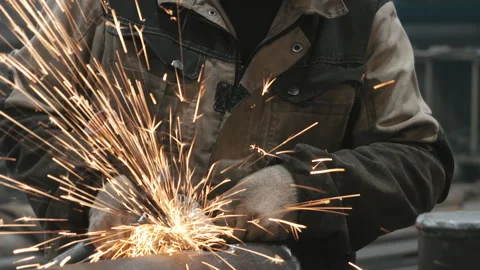 A worker at a metalworking factory processes metal. Stock Footage 306540883