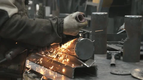 A worker at a metalworking plant processes metal. Stock Footage 306540400
