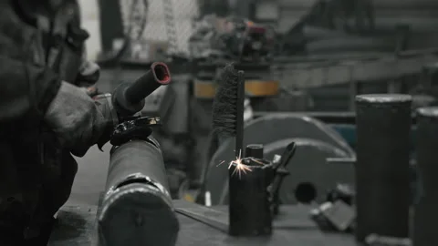 A worker at a metalworking plant processes metal. Stock Footage 306540934