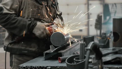 A worker at a metalworking plant processes metal. Stock Footage 313100757
