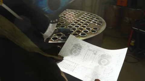 Worker of metalworking workshop look at engineering drawing of complex product Stock Footage 120064908