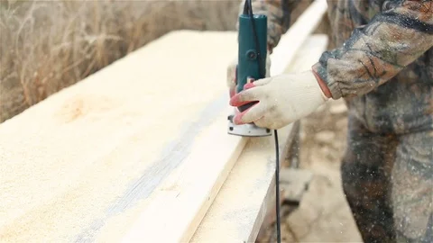 Worker milling the surface of the board Stock Footage 97858858