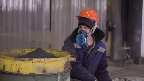 Worker mixes the mixture in a factory.  4K Stock Footage 104656716