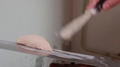 Worker Mixes the Plaster with a Spatula Video stock 77508171