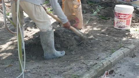 A worker is mixing cement and sand using pure water Stock Footage 157136292
