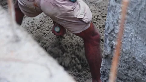 Worker mixing cement mortar for RCC wall plastering work at construction site Stock Footage 328961100