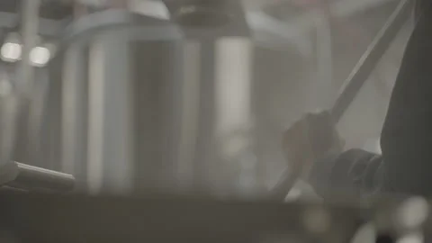 Worker mixing in large metal container Video stock 203791754